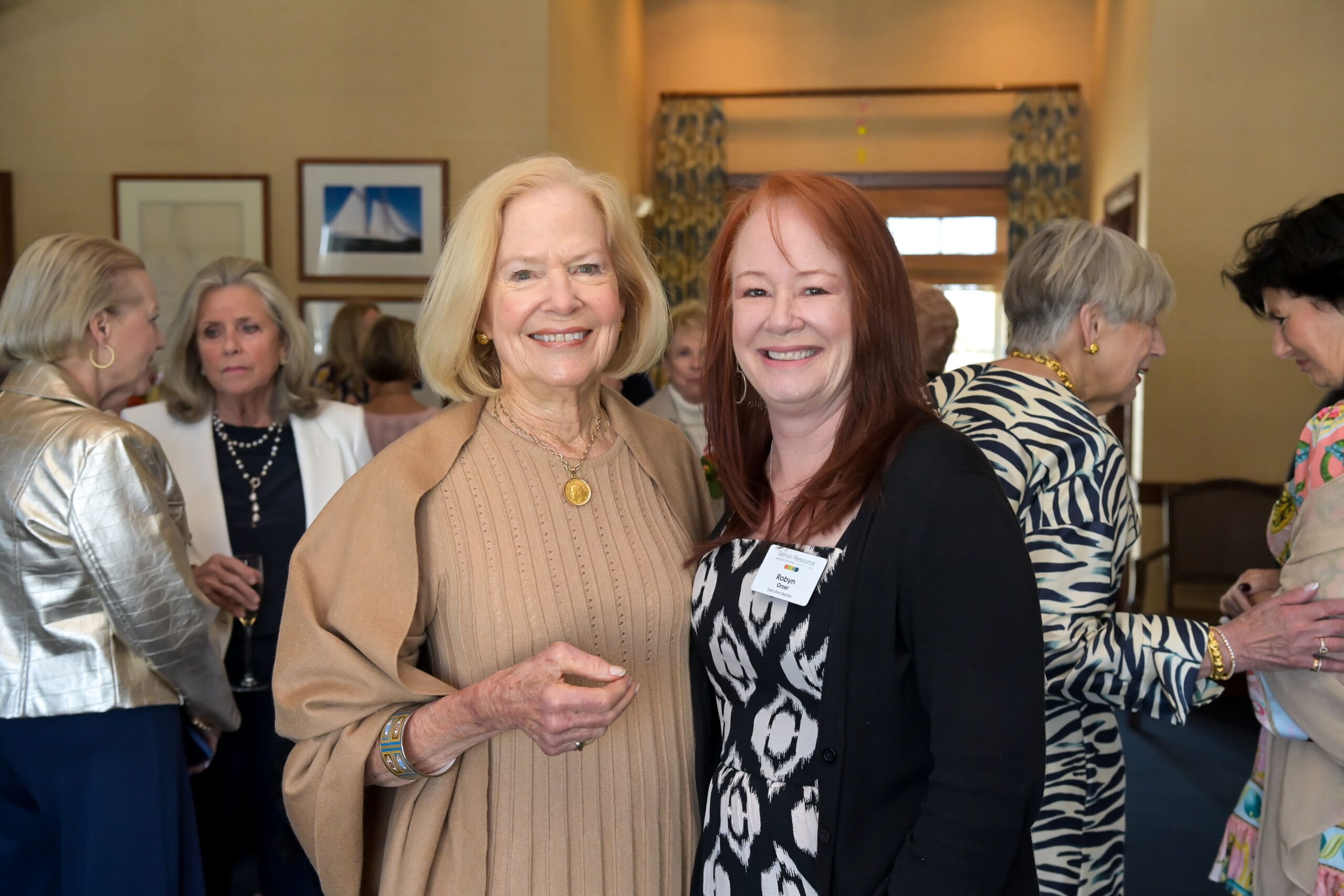 Attendees smiling for a photo with Vicki Lawrence at the luncheon.