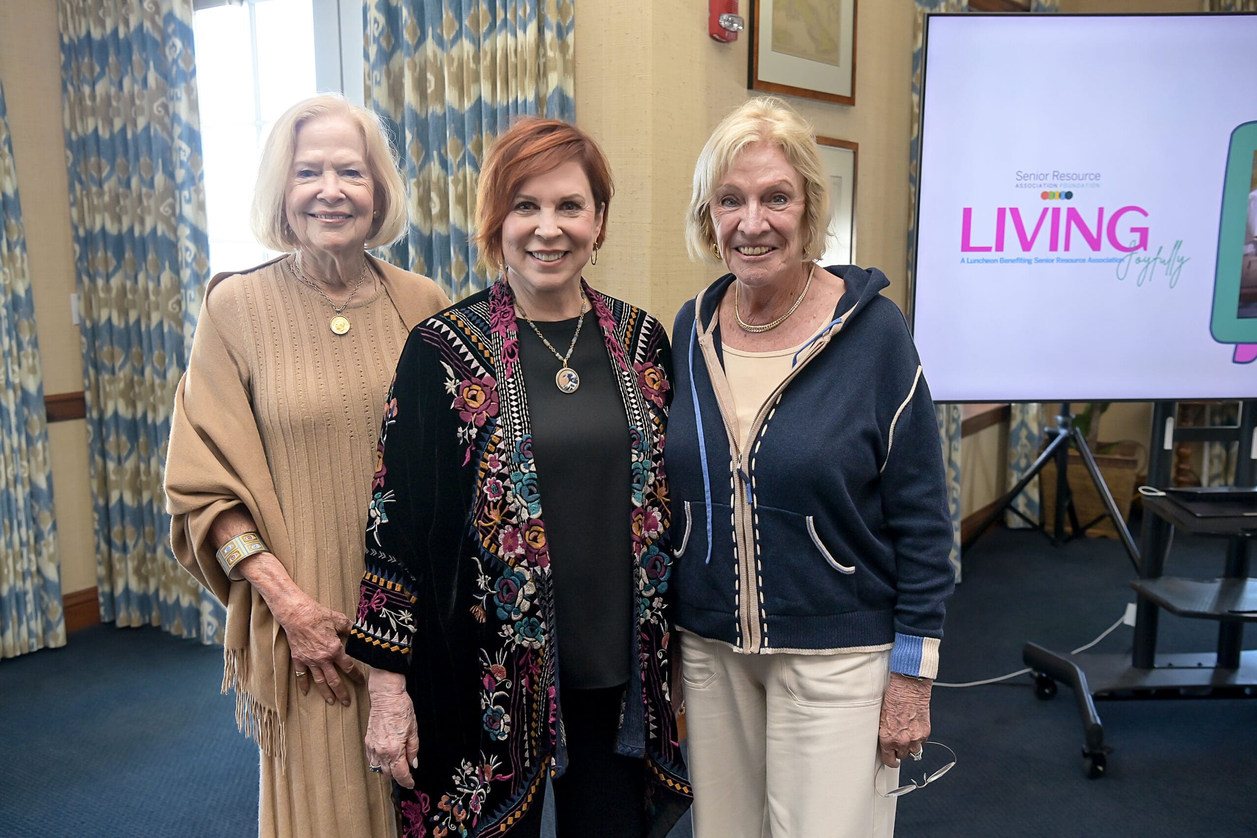 Vicki Lawrence taking a photo with event guests.