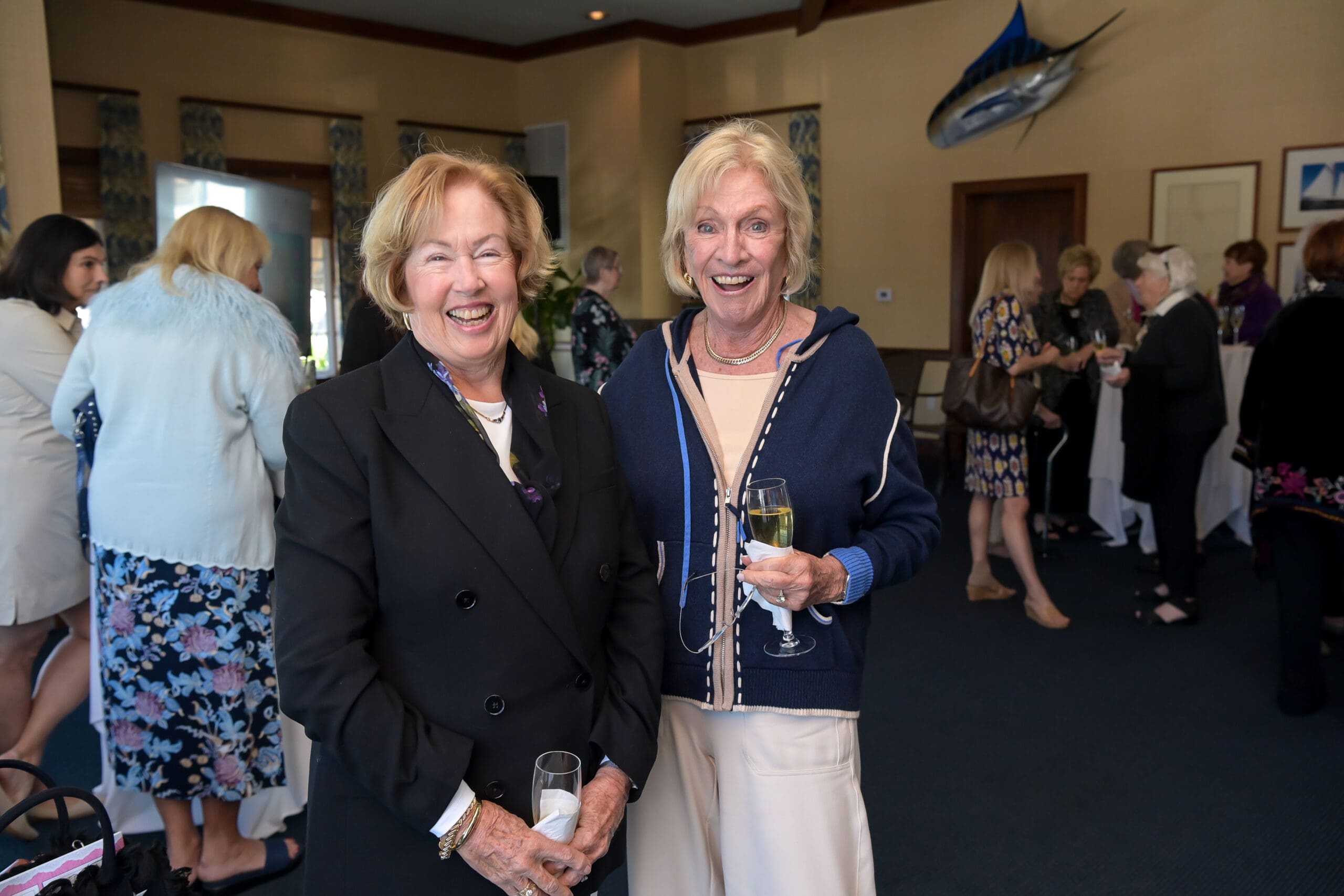 Attendees smiling for a photo at the luncheon.