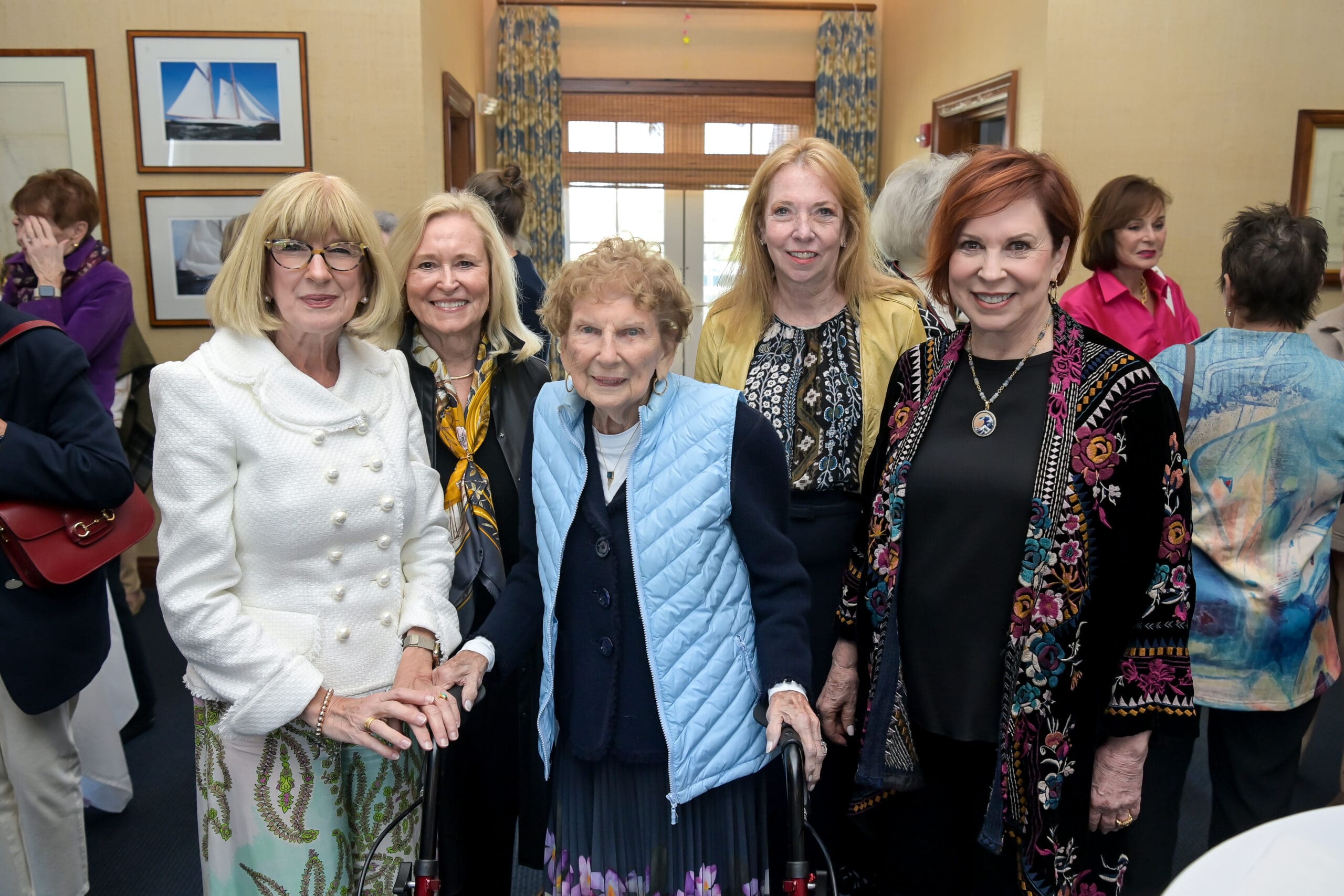 Attendees smiling for a photo with Vicki Lawrence at the luncheon.