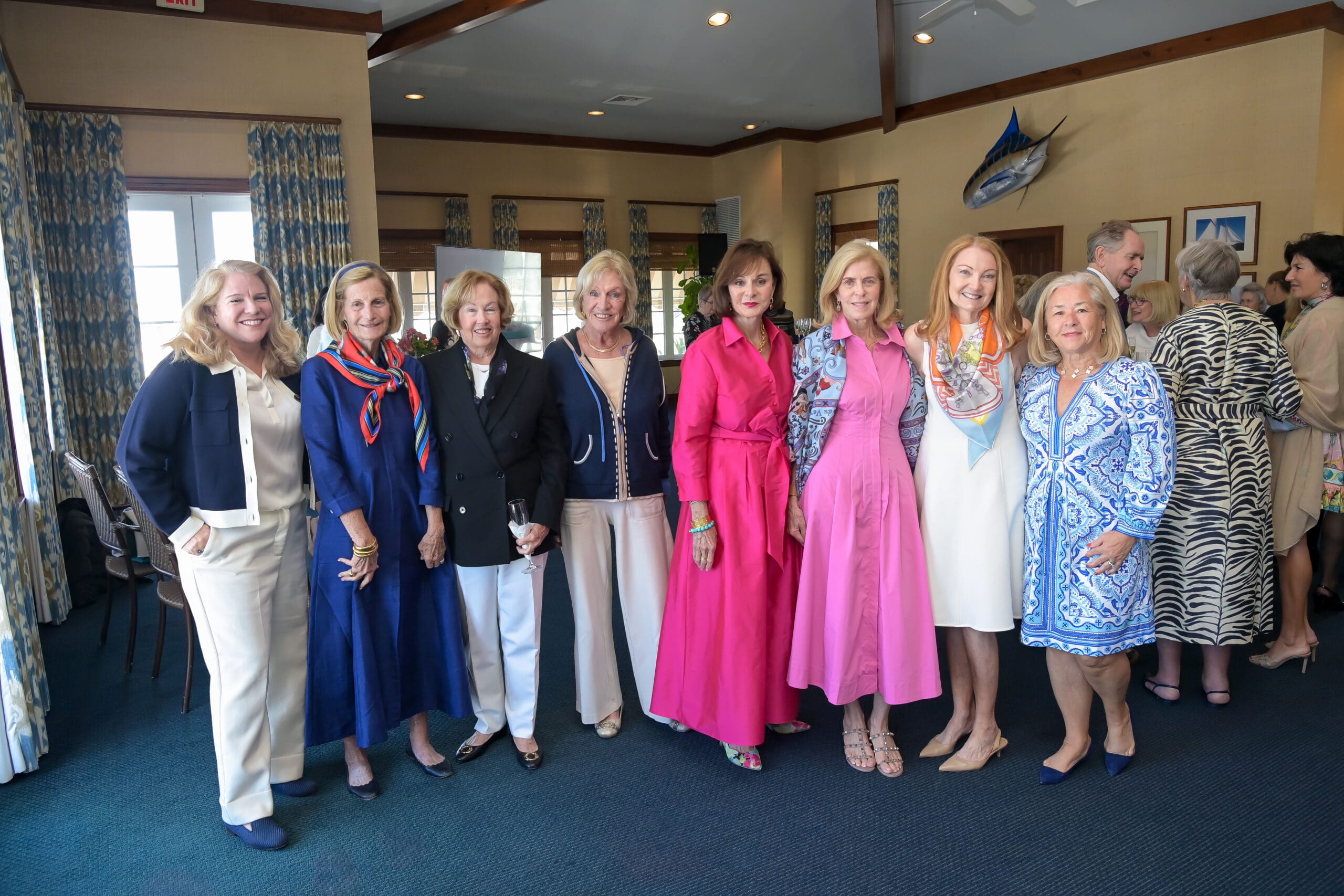 Guests posing during the Living Joyfully luncheon meet‑and‑greet.