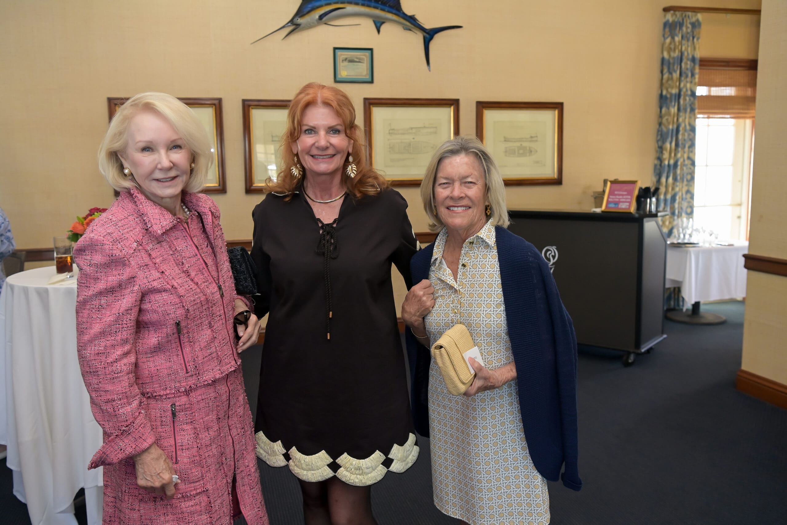 Attendees smiling for a photo at the luncheon.