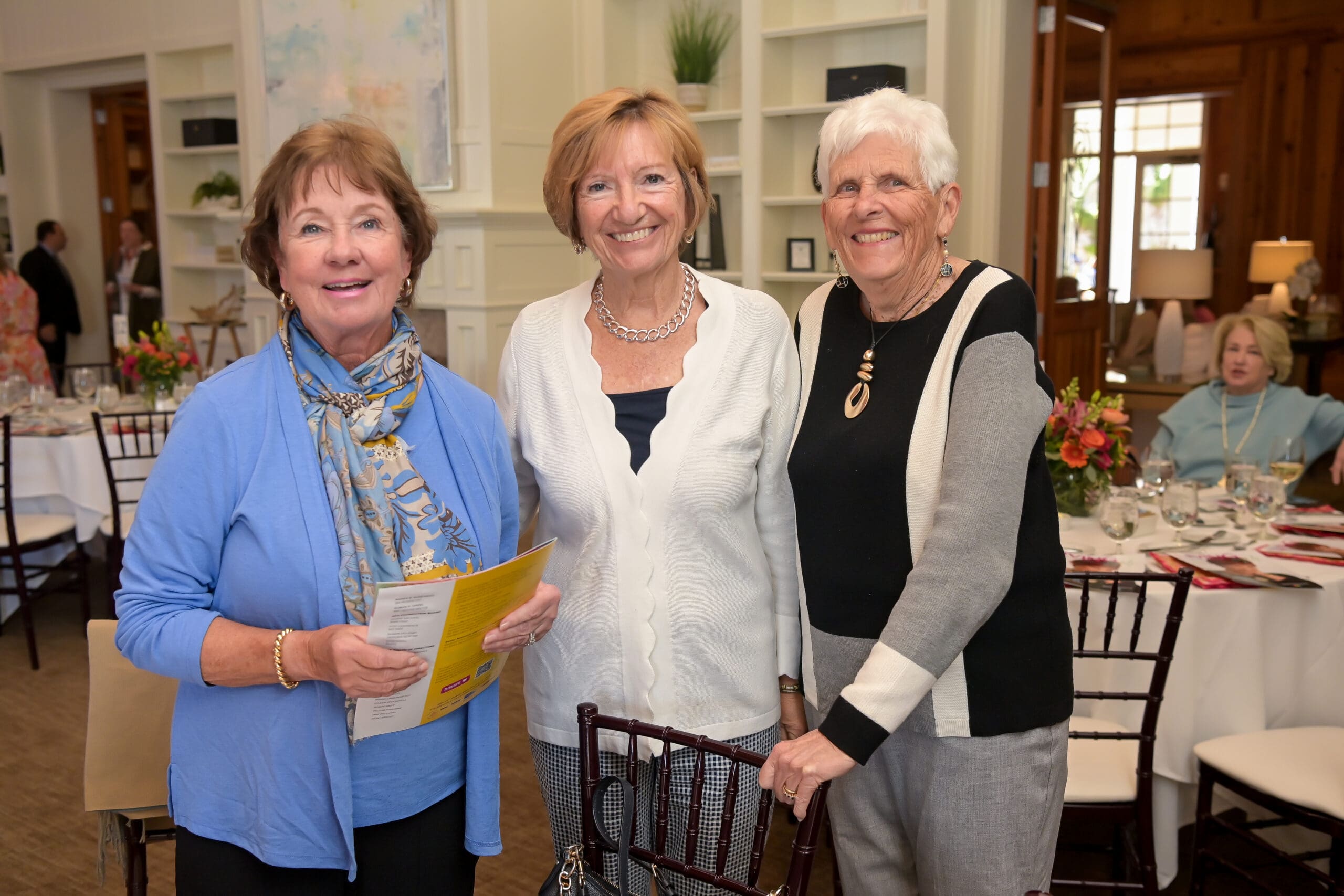 Attendees smiling for a photo at the luncheon.