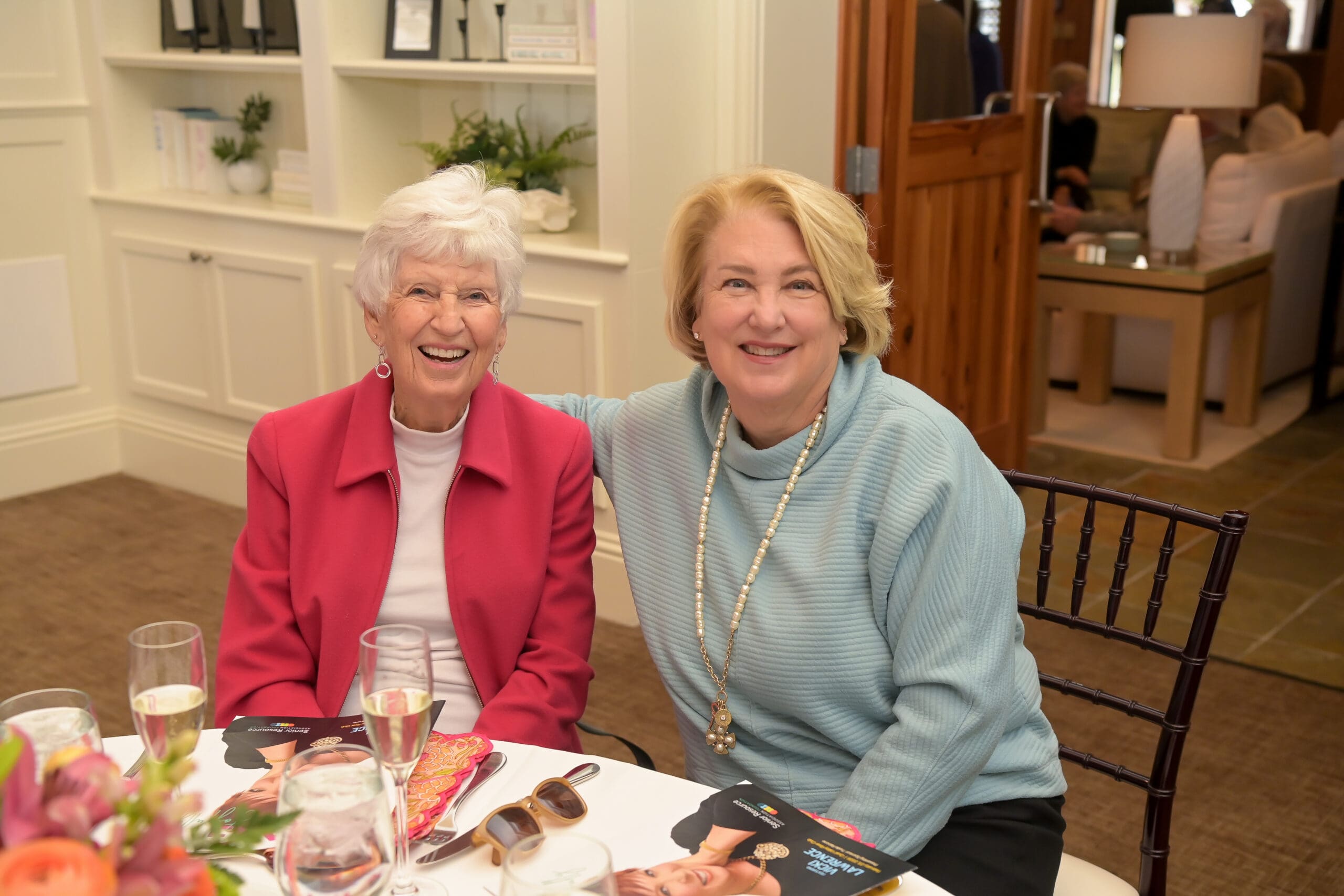Attendees smiling for a photo at the luncheon.