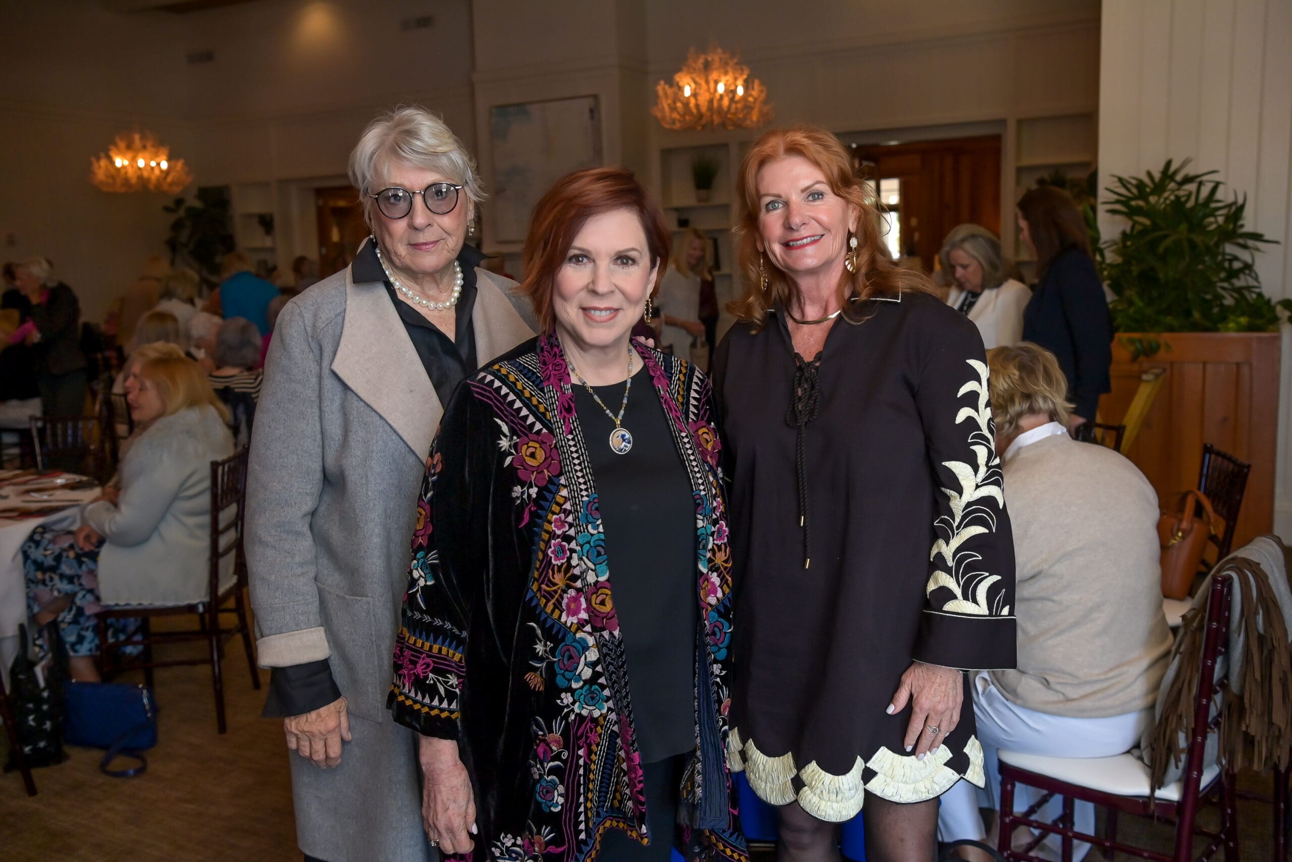Attendees smiling for a photo with Vicki Lawrence at the luncheon.