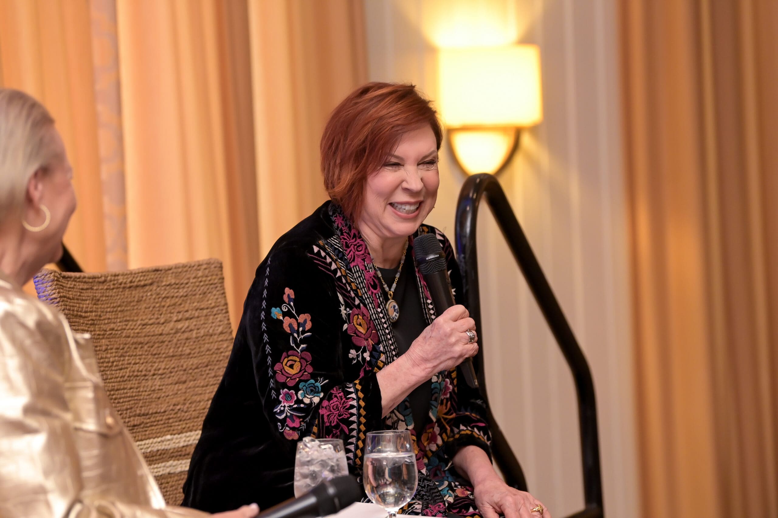 The moderator and Vicki Lawrence sharing a light moment during the luncheon program.