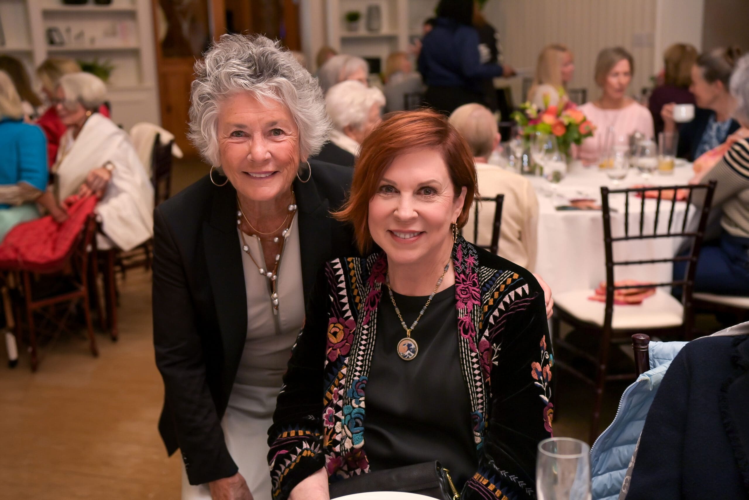 Attendees smiling for a photo with Vicki Lawrence at the luncheon.