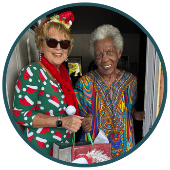 Santa for Seniors Volunteer delivers a gift to a senior.