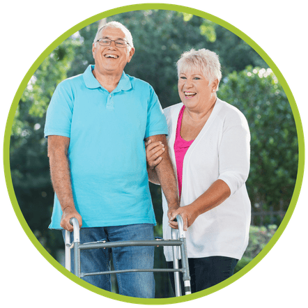 A senior using a walker while with another senior.